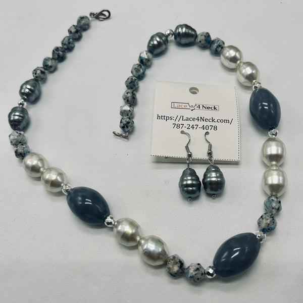 A beaded necklace and matching drop earrings displayed on a white background, with the brand card for Lace4Neck placed in the center. The jewelry features dark navy blue, silver, and white marbled beads with silver-tone metal findings.