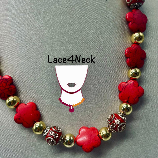 A beaded necklace with red flower-shaped beads, gold metallic beads, and ornate red-and-gold spacer beads, displayed on a gray background with a Lace4Neck logo overlay.