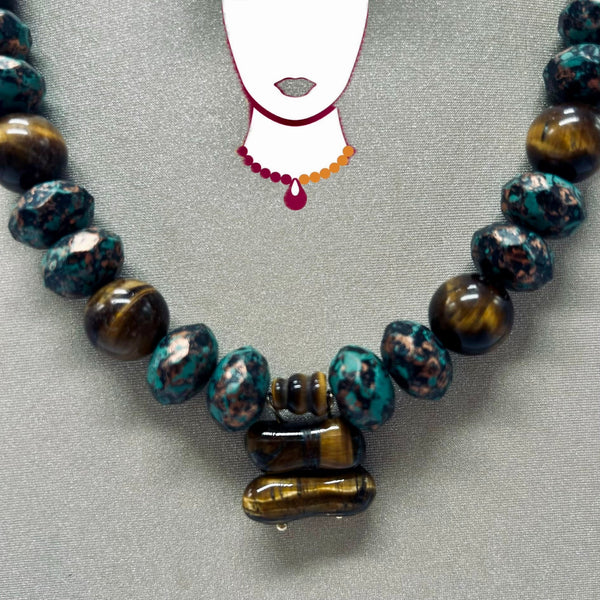 Necklace with blue and brown beads on a gray background
