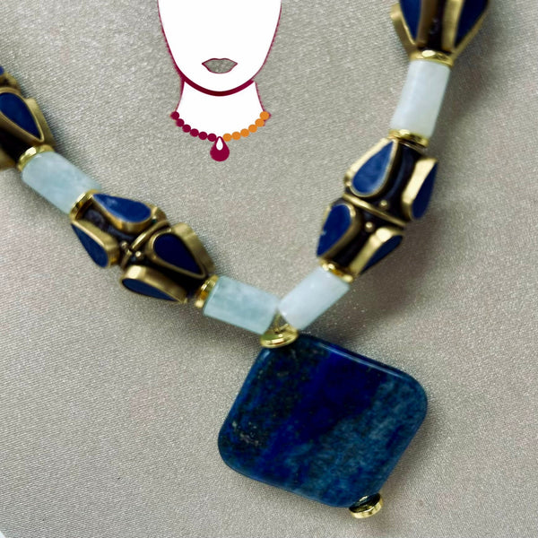 Necklace with blue and white beads on a gray background