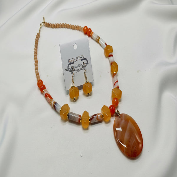 Beaded necklace with a large brown pendant on a white background