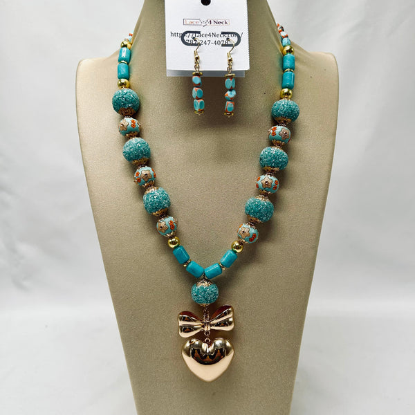 Turquoise beaded necklace with a bow pendant on a beige display stand.