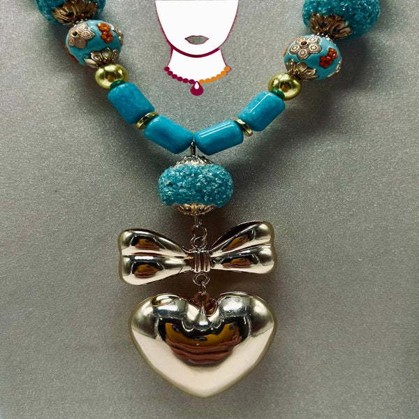 Necklace with blue beads and a silver bow and heart pendant on a gray background