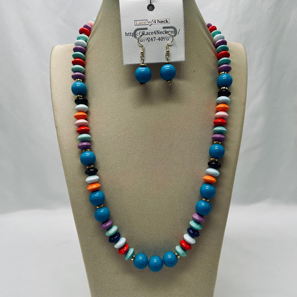 Colorful beaded necklace and matching earrings on a mannequin bust with a visible brand tag.