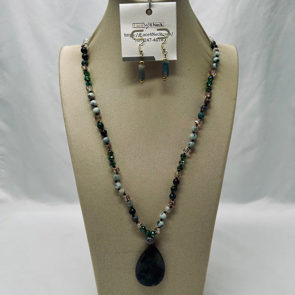 Necklace with black teardrop pendant on a mannequin bust with a visible brand tag.