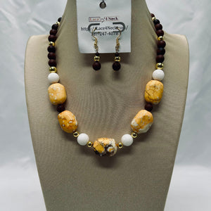 Necklace and earrings set on a mannequin bust with a visible brand tag.