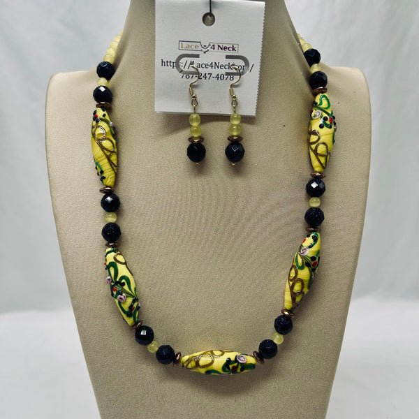 Necklace and earrings set on a mannequin with a visible brand tag.