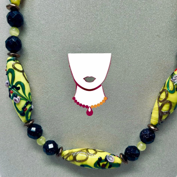 Necklace with colorful beads on a gray background
