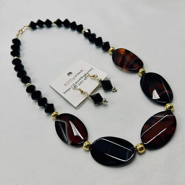Necklace with black and brown beads on a white background