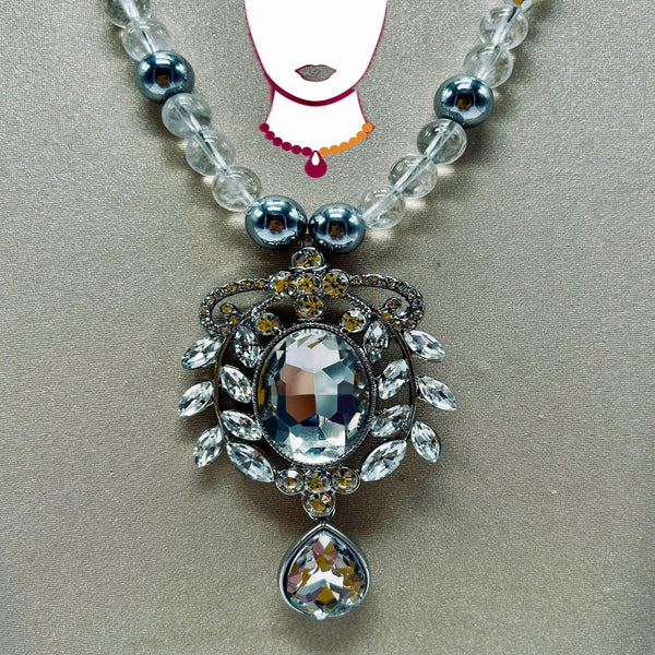 Necklace with decorative pendant on a neutral background