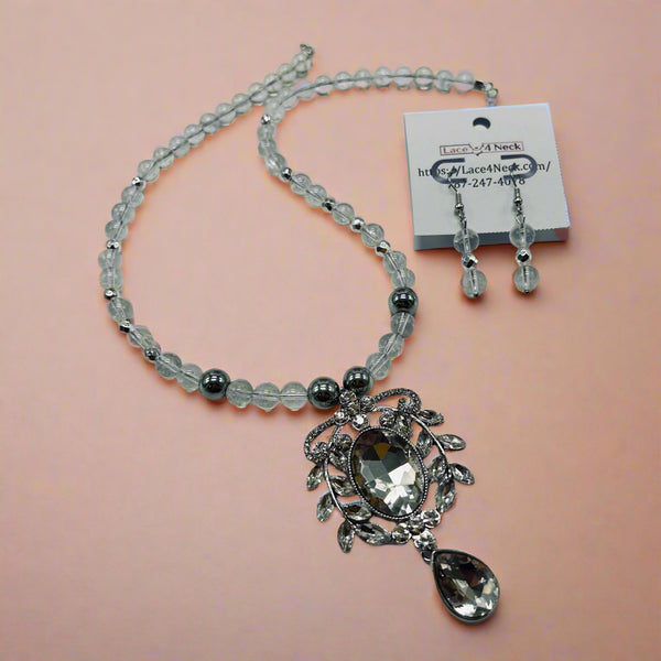 Necklace with pendant and beads on a light gray background