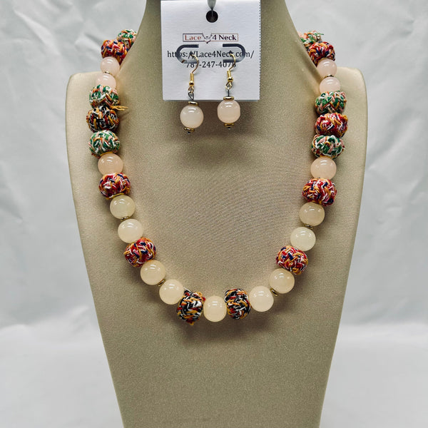Necklace and earrings set on a mannequin bust with a visible brand tag.