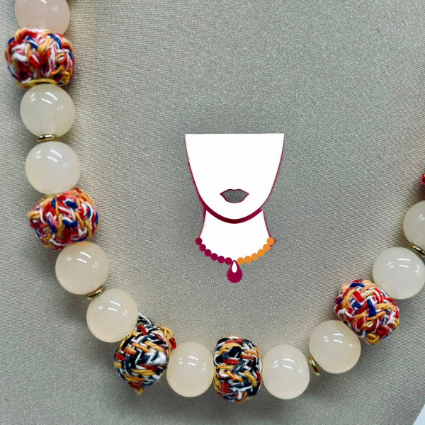 Necklace with colorful beads and a face mask design on a gray background