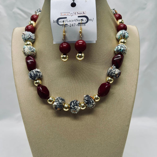Necklace and earrings set on a mannequin with a visible brand tag.
