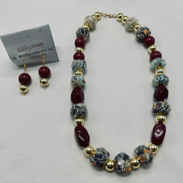 Beaded necklace and earrings set on a white background