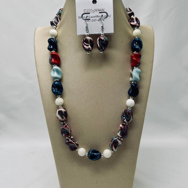 Necklace and earrings set on a mannequin bust with a visible brand tag.