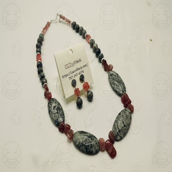 Necklace with marbled stones and red beads on a white background