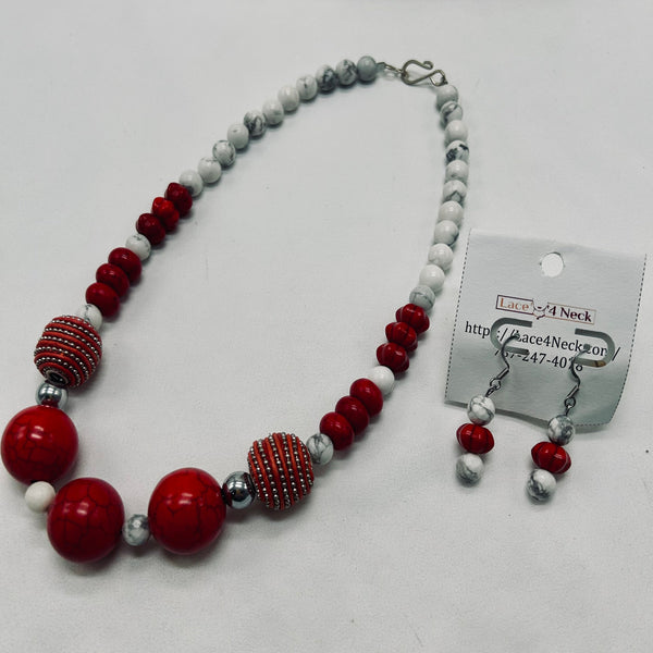 Necklace with red, gray, and white beads on a white background