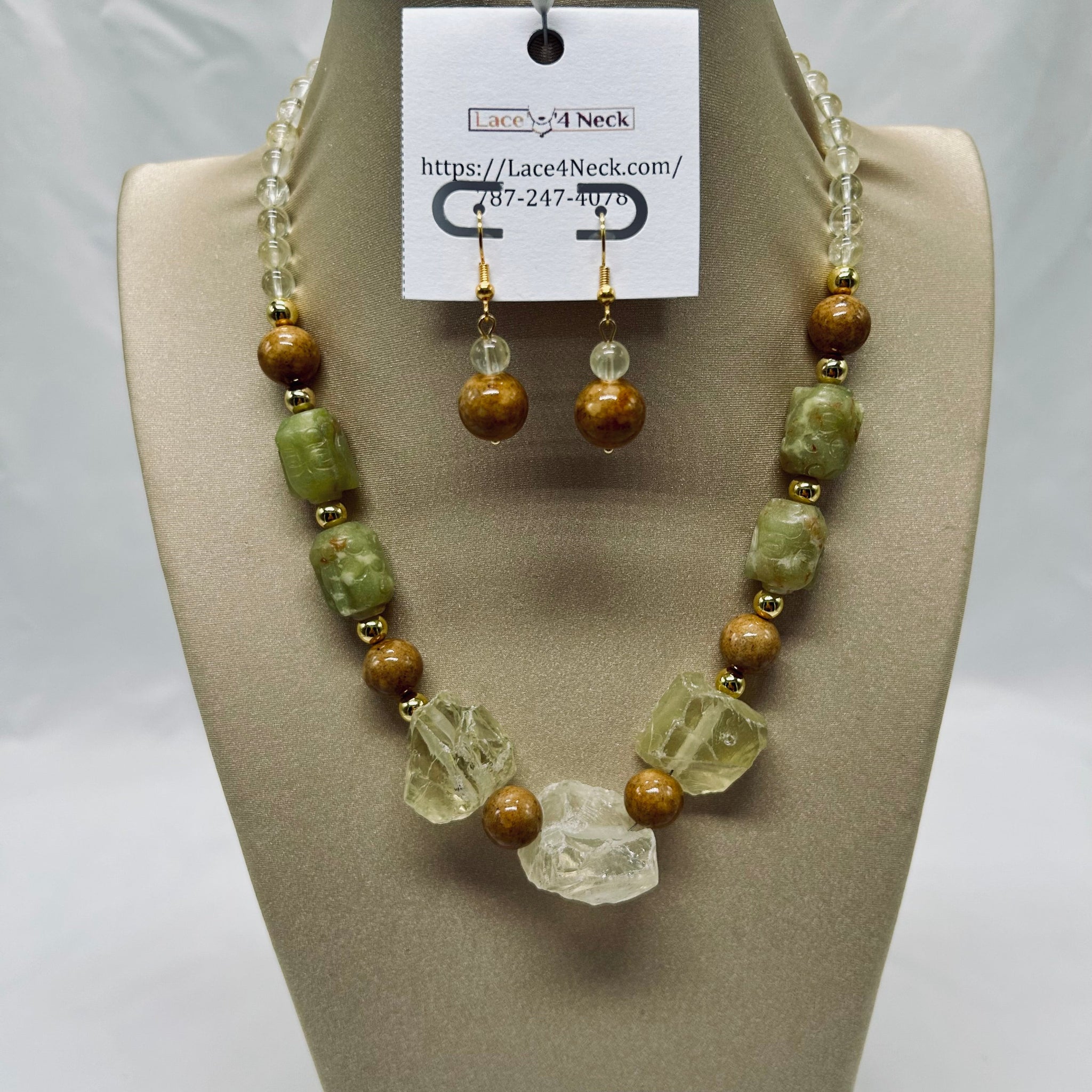 Jewelry set with necklace and earrings on a mannequin bust, featuring green and brown beads.