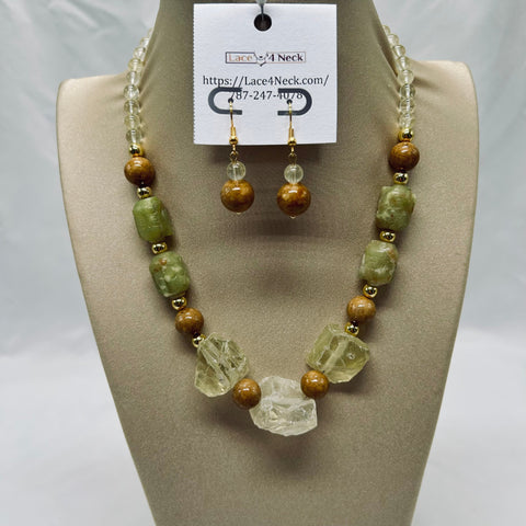 Jewelry set with necklace and earrings on a mannequin bust, featuring green and brown beads.