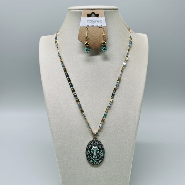 Necklace and earrings on a mannequin bust with a green background