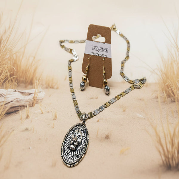 Jewelry set with necklace, earrings, and card on a sandy background