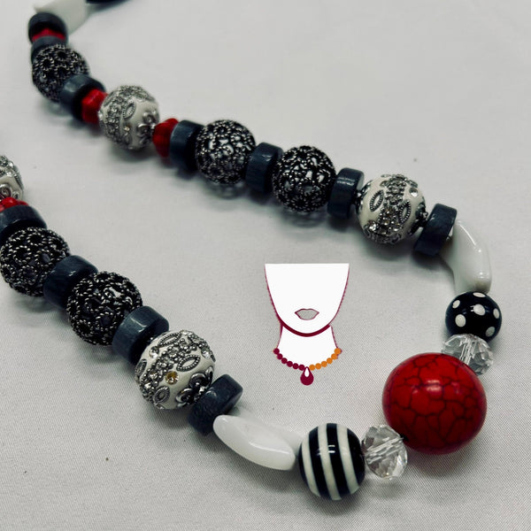 Necklace with various beads on a light gray background