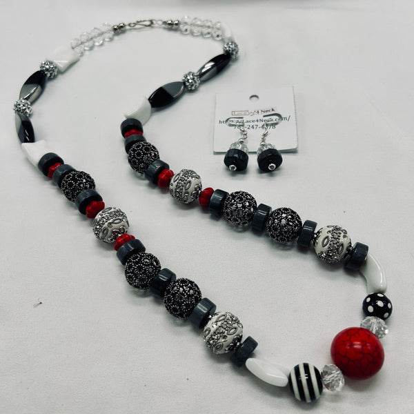 Beaded necklace with black, red, and silver beads on a white background