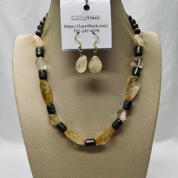 Jewelry set with necklace and earrings on a display stand, featuring beads in black and beige.