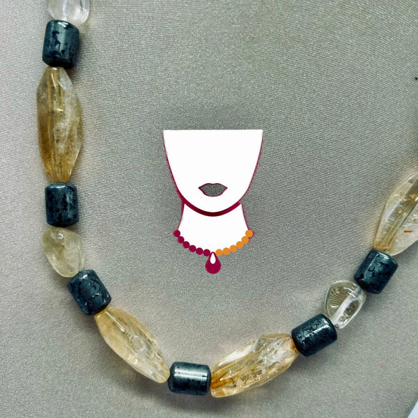 Necklace with black and clear beads on a gray background