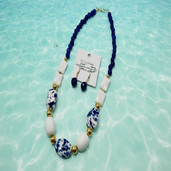 Necklace with blue, white, and gold beads on a white background