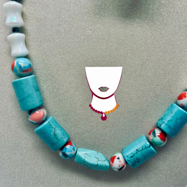 A turquoise and marbled bead necklace arranged in a circle on a textured gray background, featuring large round turquoise beads, smaller patterned beads, and white beads at the top left.