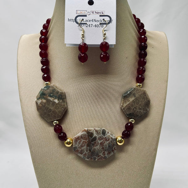 Necklace and earrings set on a mannequin bust with a visible brand tag.