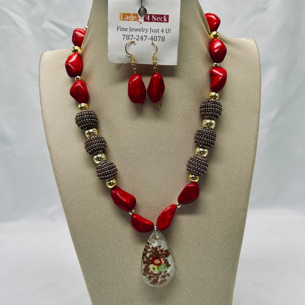 Necklace and earrings set on a beige display with a visible brand tag.