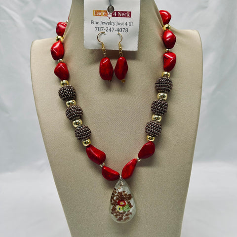 Necklace and earrings set on a beige display with a visible brand tag.