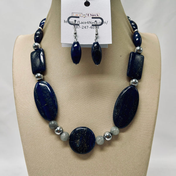 Necklace and earrings set on a mannequin bust with a visible brand tag.