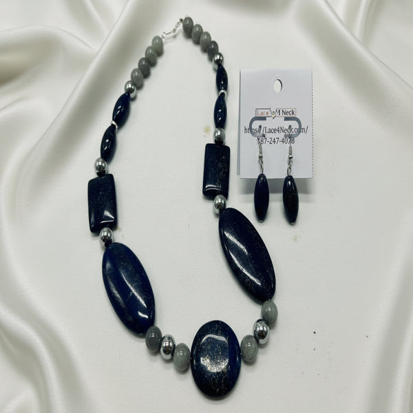 Necklace and earrings set with blue and gray beads on a white background