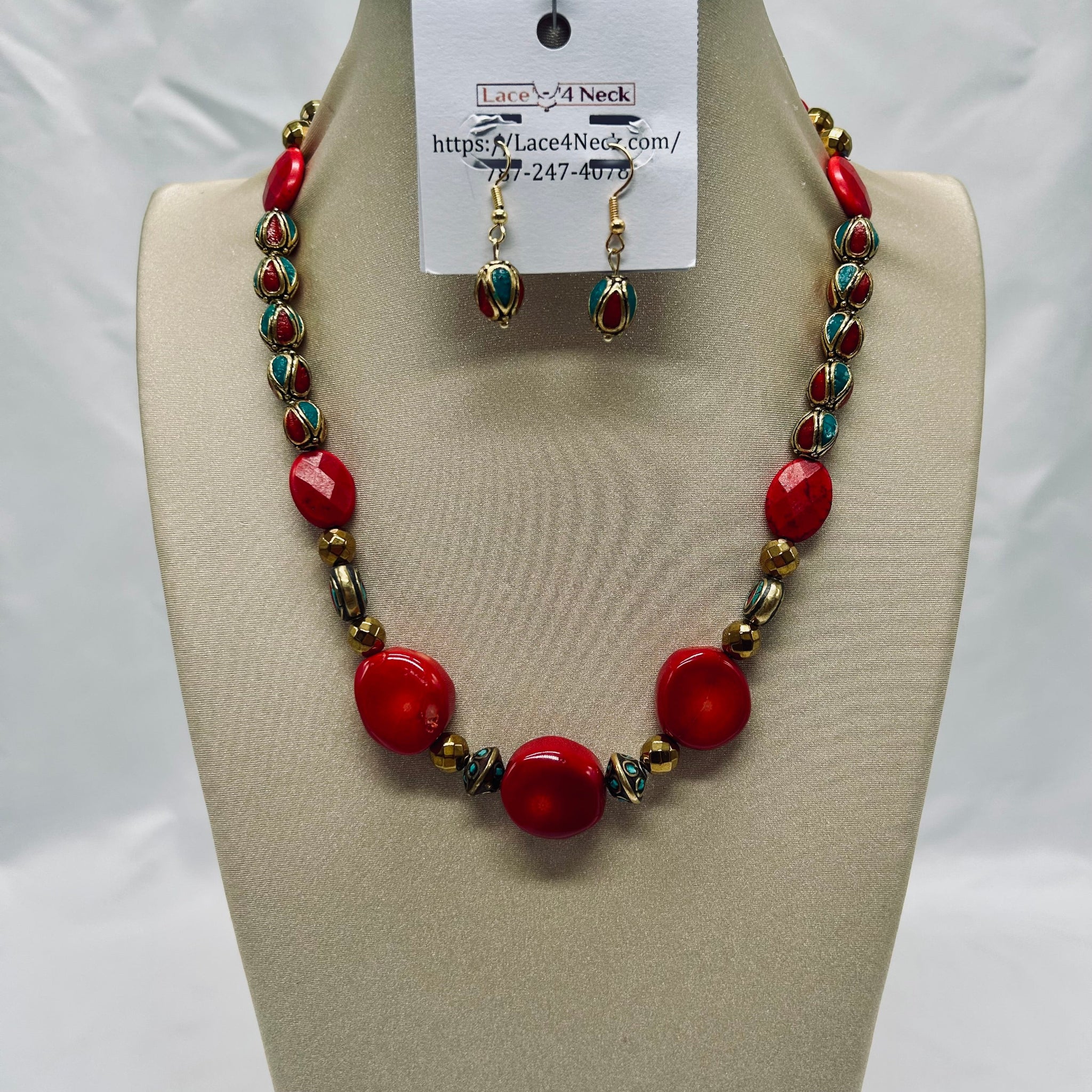 Necklace and earrings set on a mannequin bust with a visible brand tag.