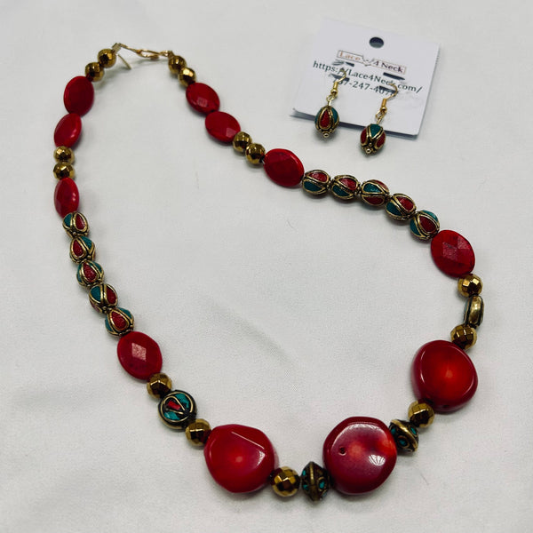 Necklace with red beads and gold accents on a white background