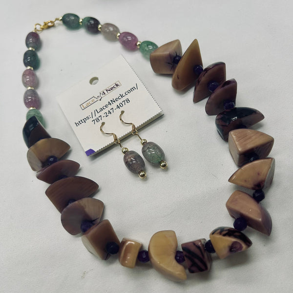 A jewelry set featuring a chunky beaded necklace and matching drop earrings on a white background. The necklace and earrings are made of polished natural stone beads in earthy brown, beige, purple, and green hues, accented with small gold-toned spacers and hooks.
