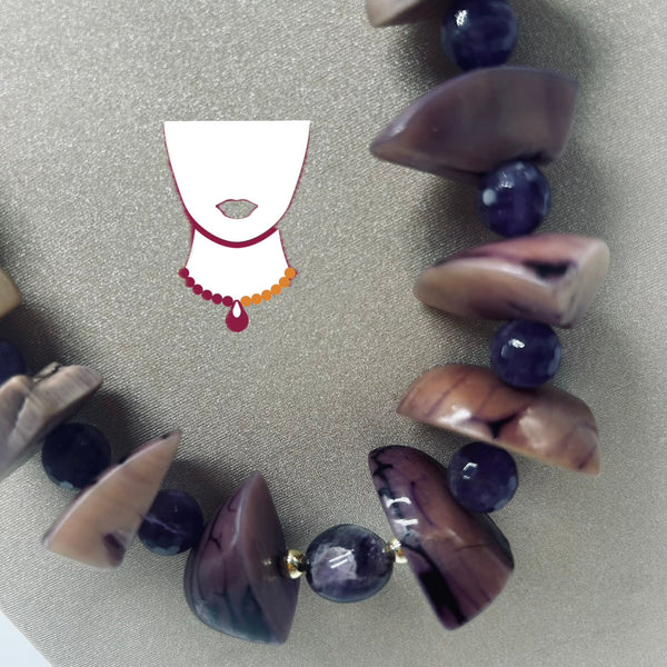 A beaded necklace with polished dark purple and brown stone beads, displayed on a textured gray background with a small white necklace graphic overlay.