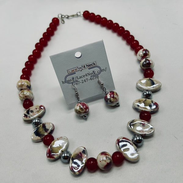 Necklace with red and silver beads on a white background