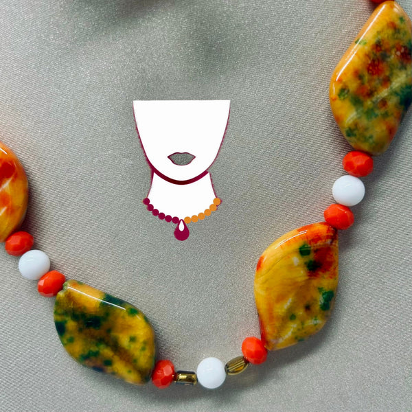 Necklace with colorful beads on a gray background