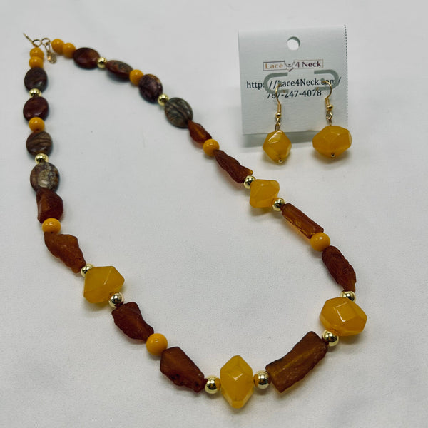 Necklace and earrings set with brown and yellow beads on a white background