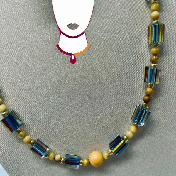 Necklace with blue and beige beads on a gray background