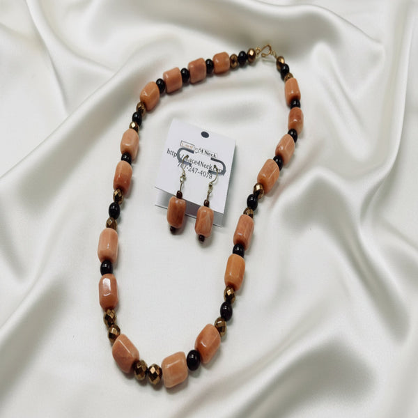 Necklace and earrings set with brown and black beads on a white background