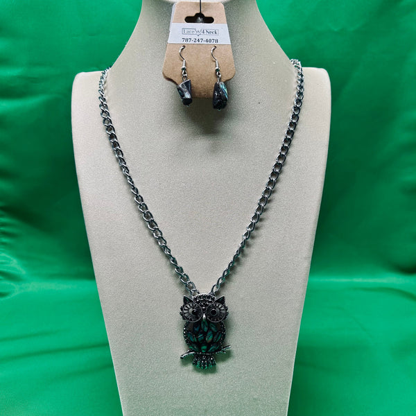 Necklace with owl pendant on a mannequin bust against a green background