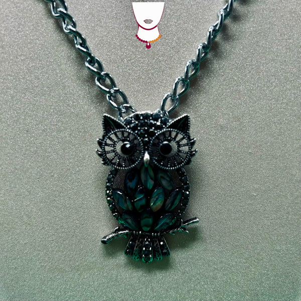 Owl-shaped pendant necklace on a gray background