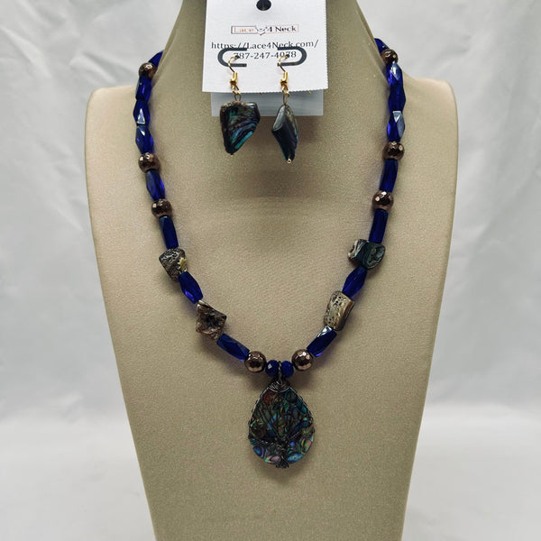 Jewelry set with blue beaded necklace and earrings on a mannequin bust.