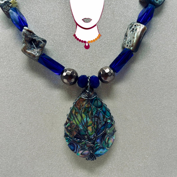 Necklace with blue and silver beads on a gray background